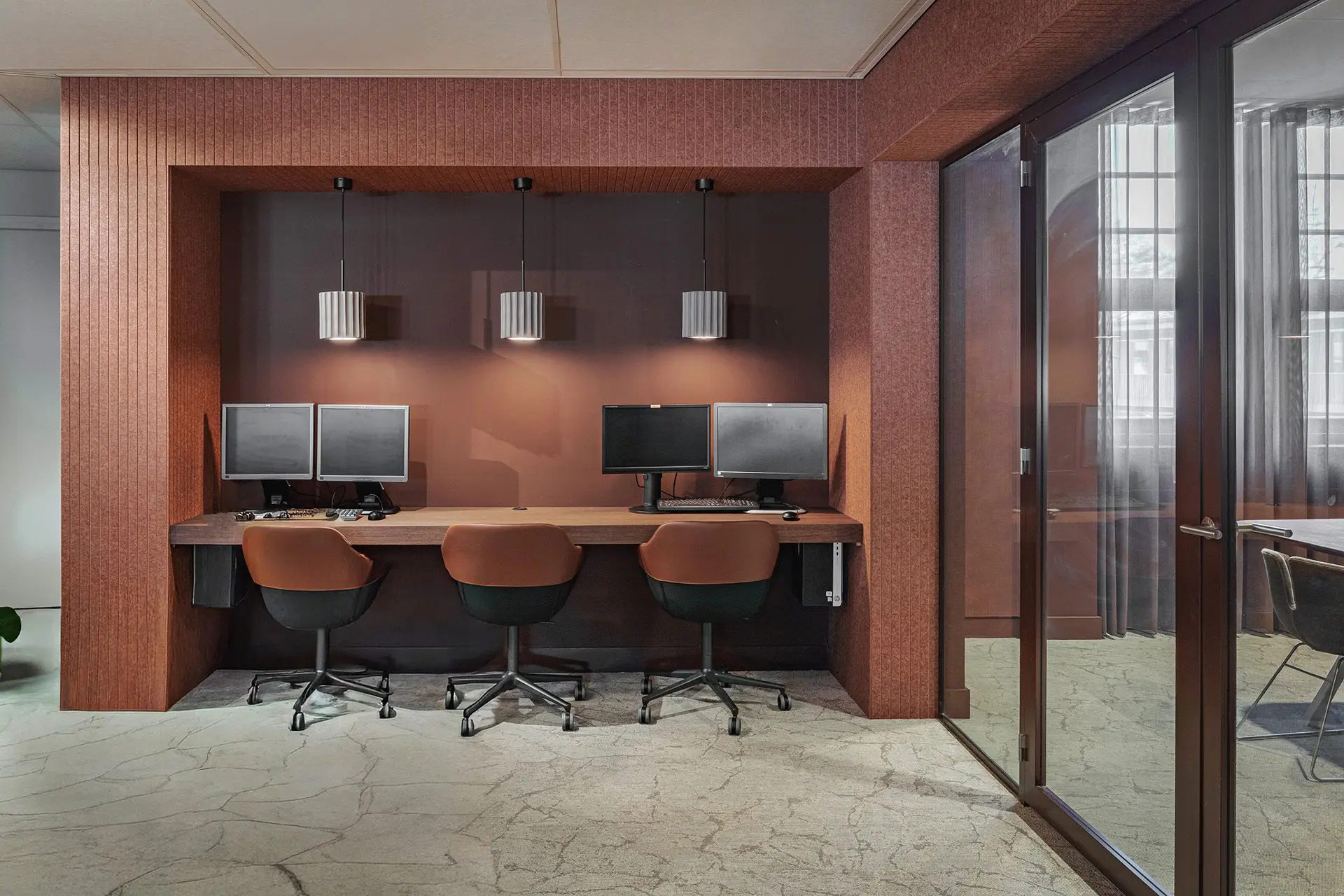 Modern office workspace with three computers